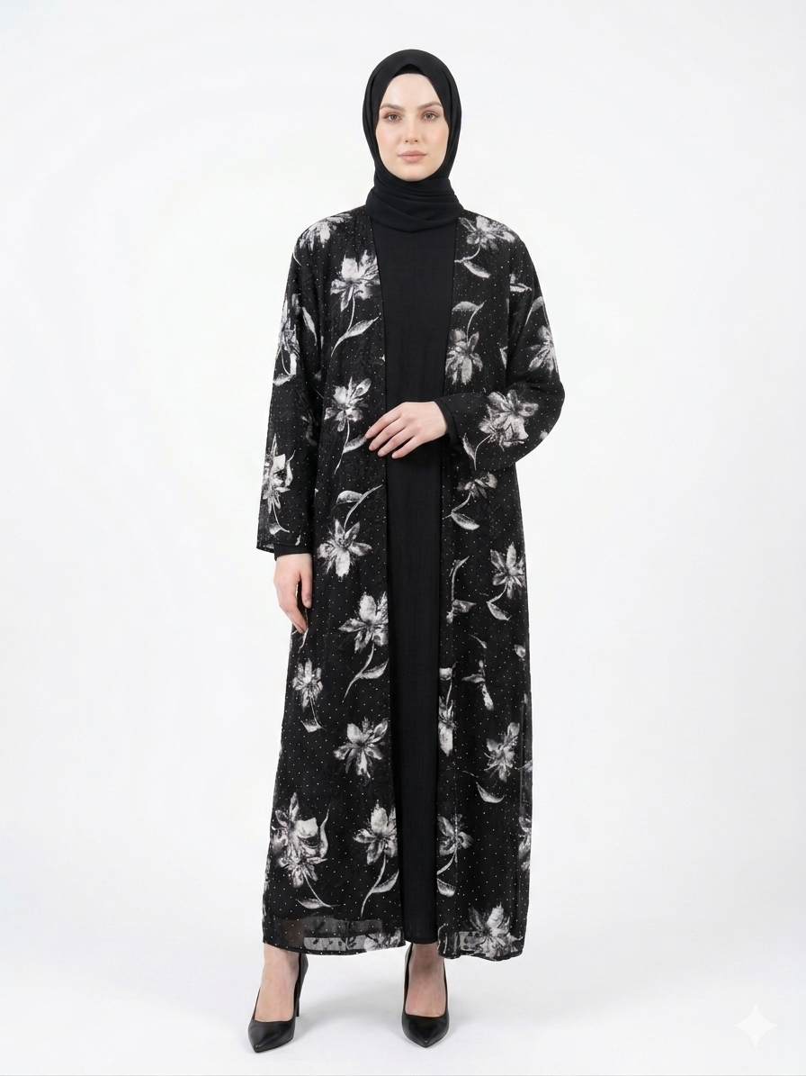 Fair-skinned model wearing the Rizqé Midnight Flora sheer black floral kimono abaya set with a matching black inner dress and hijab against a solid white background.