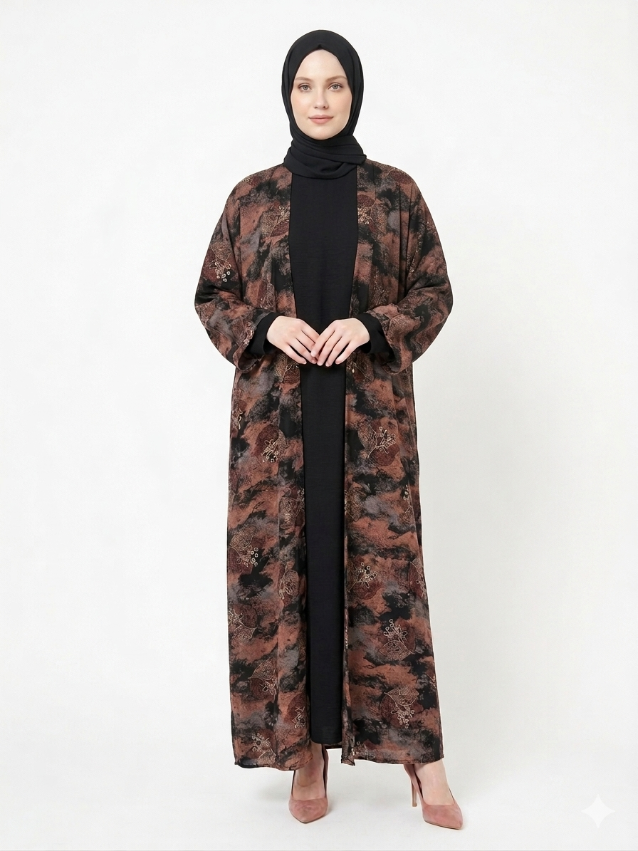 Fair-skinned model with grey eyes wearing the Rizqé Chocolate & Black Pashmina Print Nida abaya featuring a black front panel and full printed back against a solid white studio background.