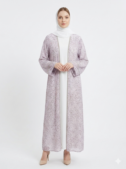 Fair-skinned model with grey eyes wearing the Rizqé Lavender Radiance sheer lavender floral kimono abaya set with a matching white inner dress and hijab against a solid white studio background.